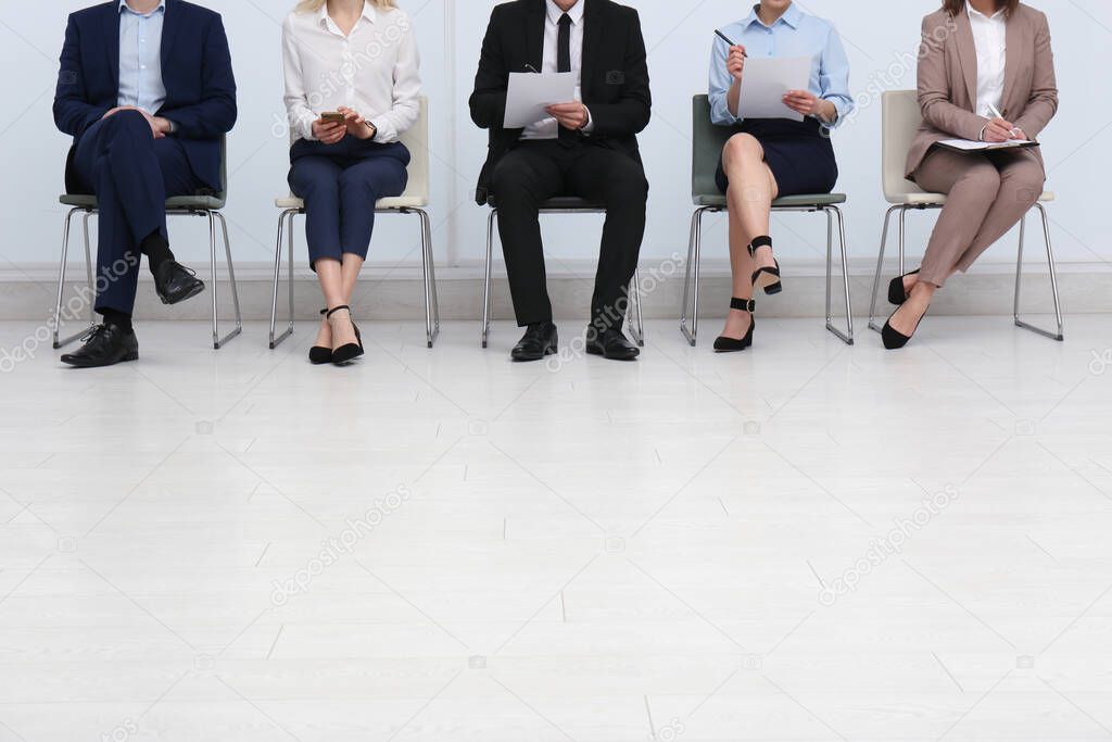 People waiting for job interview in office hall, closeup