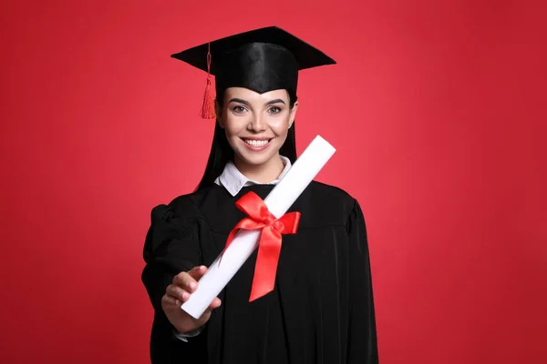 Gelukkige Student Met Afstudeerhoed Diploma Rode Achtergrond — Stockfoto