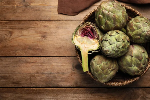 Cut Whole Fresh Raw Artichokes Basket Wooden Table Top View — Stock Photo, Image