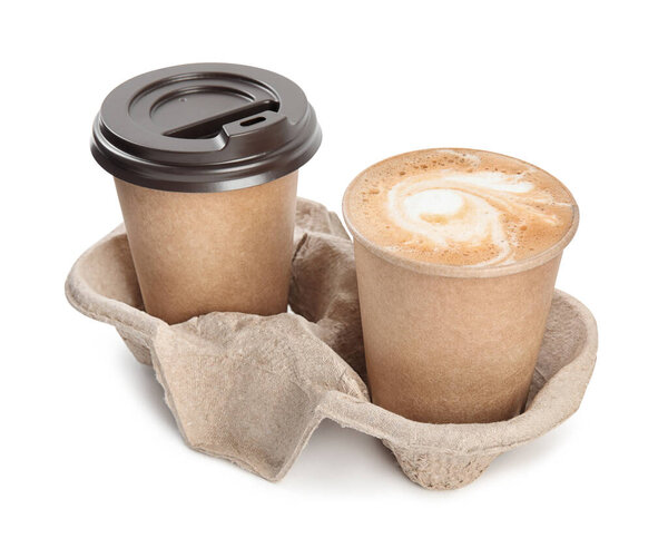 Takeaway paper cups with coffee in cardboard holder on white background