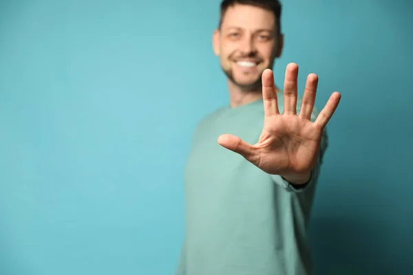 Left Handed Man Light Blue Background Focus Palm Space Text — Stock Photo, Image