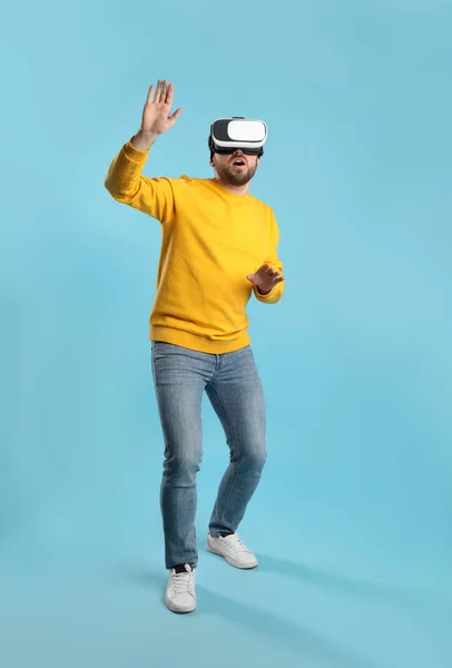 Emotional Man Using Virtual Reality Headset Light Blue Background — Stock Photo, Image