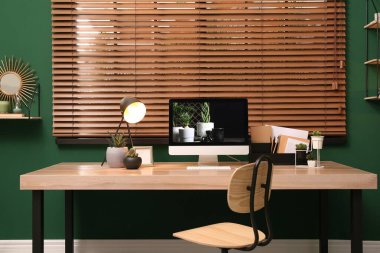 Odanın penceresine yakın modern bilgisayarlı rahat bir iş yeri. İç tasarım