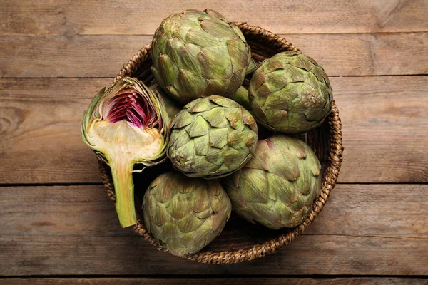 Cut Whole Fresh Raw Artichokes Basket Wooden Table Top View — Stock Photo, Image