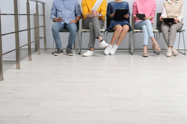 People waiting for job interview in office hall, closeup