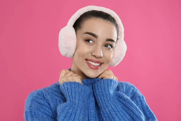 Hermosa Mujer Joven Con Orejeras Sobre Fondo Rosa —  Fotos de Stock