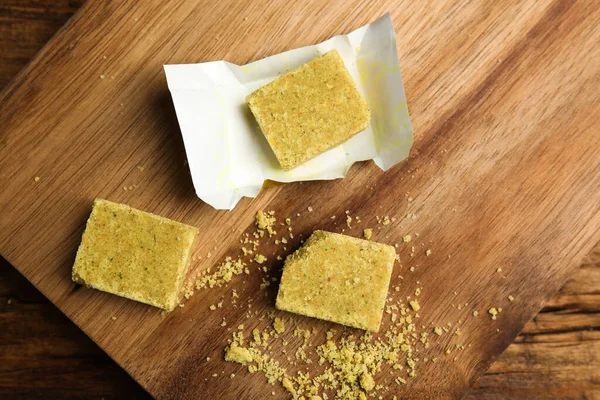 Bouillon cubes on wooden table, top view