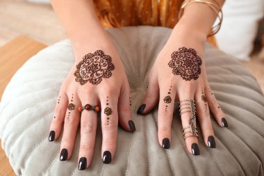 Elinde kına dövmesi olan bir kadın, yakın plan. Geleneksel mehndi süsü