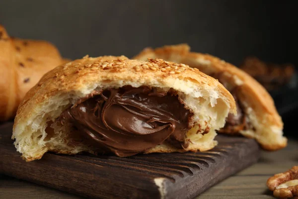 Tasty Croissant Chocolate Sesame Seeds Wooden Board Closeup — Stock Photo, Image