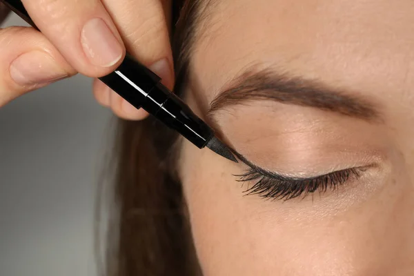 Artist Applying Black Eyeliner Woman Face Grey Background Closeup — Stock Photo, Image