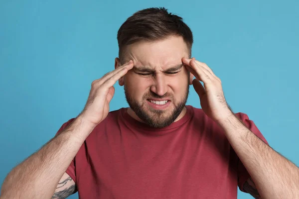 Man Suffering Migraine Light Blue Background — Stock Photo, Image