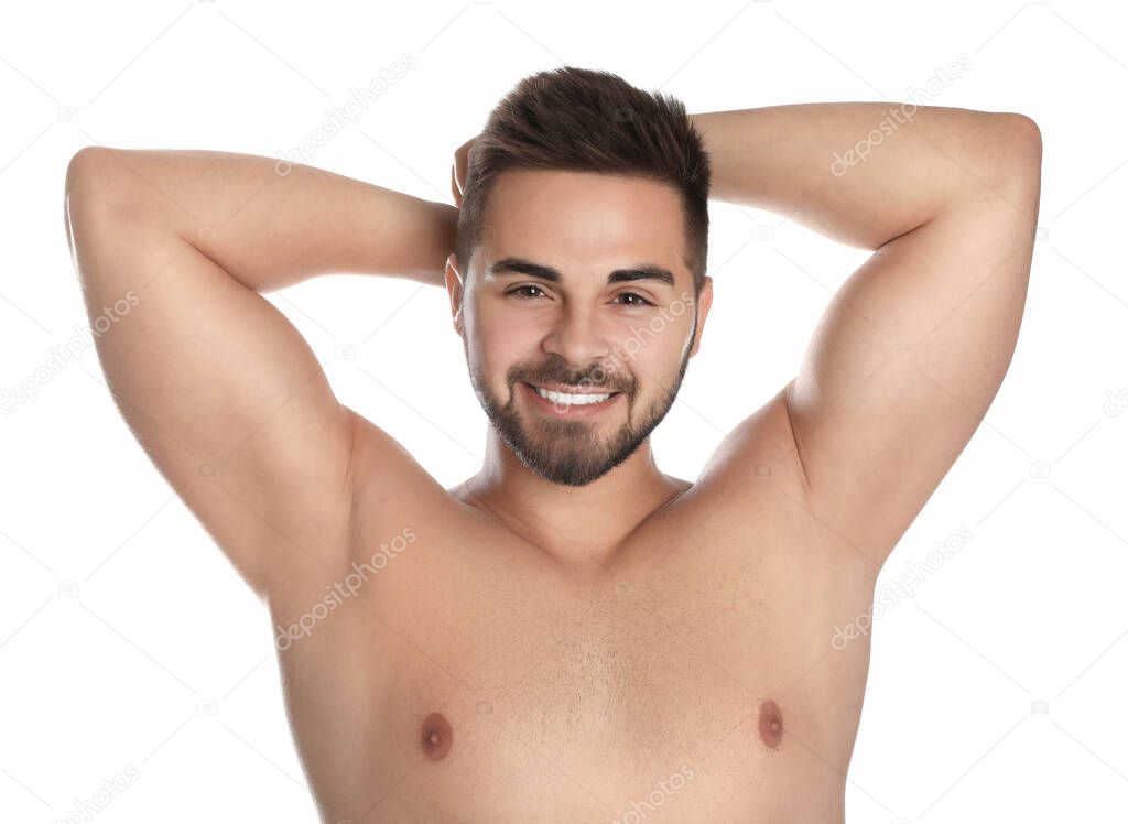 Young man showing hairless armpits after epilation procedure on white background