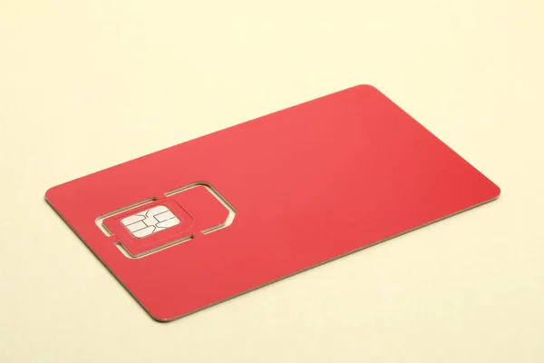 Modern Red Sim Card Beige Background Closeup — Stock Photo, Image