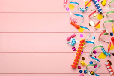 Düz kompozisyon ve pembe ahşap arka planda karnaval eşyaları. Metin için boşluk