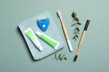 Flat lay composition with teeth care items on light grey blue background