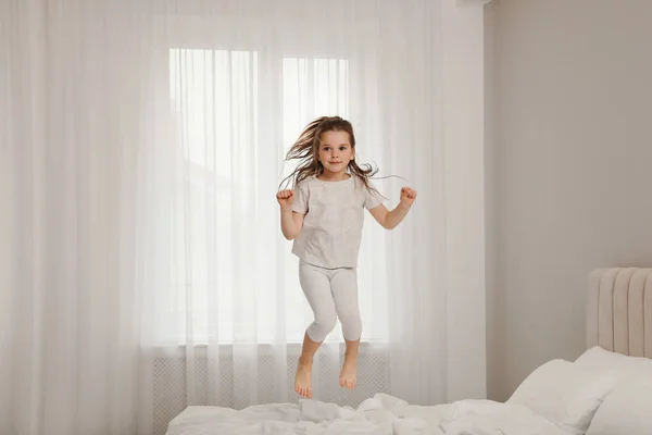 Cute Little Girl Jumping Bed Home — Stock Photo, Image