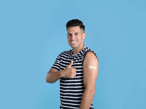 Vaccinated Man Medical Plaster His Arm Showing Thumb Light Blue — 스톡 사진