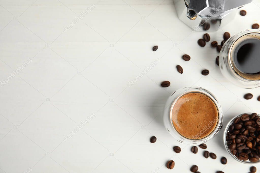 Tasty coffee and beans on white wooden table, flat lay. Space for text