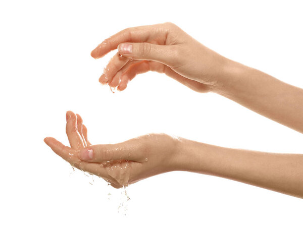 Woman with water in her hands on white background, closeup