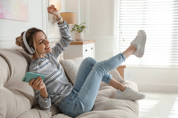 Young woman listening to music at home