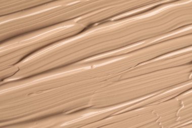 Texture of liquid skin foundation as background, closeup clipart