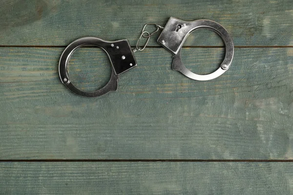 Classic Chain Handcuffs Blue Wooden Table Top View Space Text — Stock Photo, Image