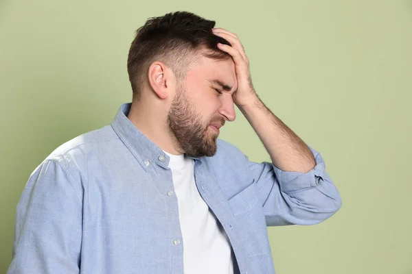 Man Suffering Migraine Light Green Background — Stock Photo, Image