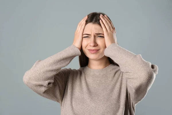 Junge Frau Mit Migräne Auf Grauem Hintergrund — Stockfoto