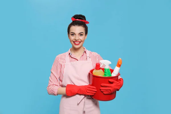 Young Housewife Holding Bucket Cleaning Supplies Light Blue Background — Stock Photo, Image