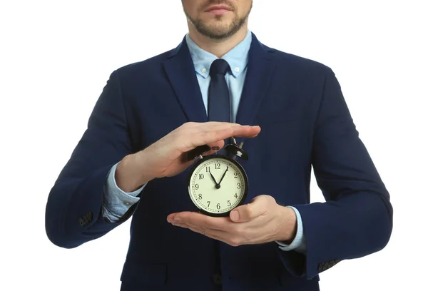 Stock image Businessman holding alarm clock on white background, closeup. Time management