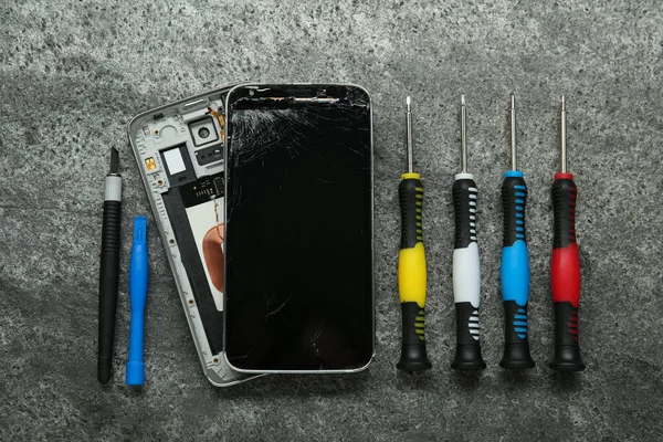 Μέρη Κατεστραμμένων Smartphone Και Εργαλείο Επισκευής Που Γκρι Τραπέζι Επίπεδη — Φωτογραφία Αρχείου