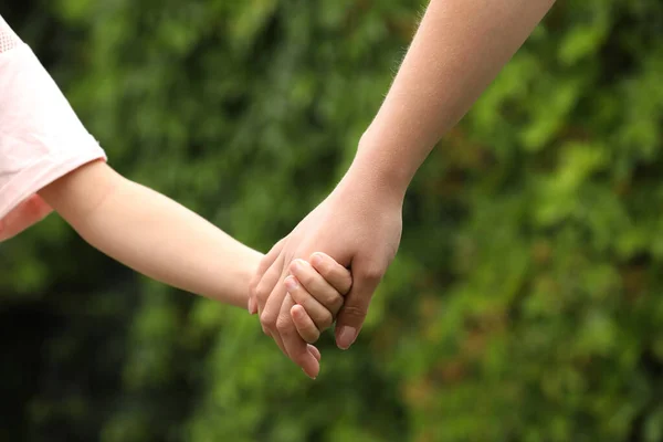 女性と子供が屋外で手を取り合って — ストック写真