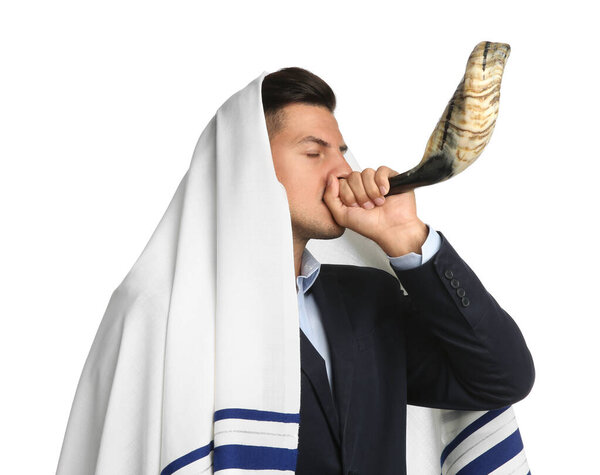 Jewish man in tallit blowing shofar on white background. Rosh Hashanah celebration