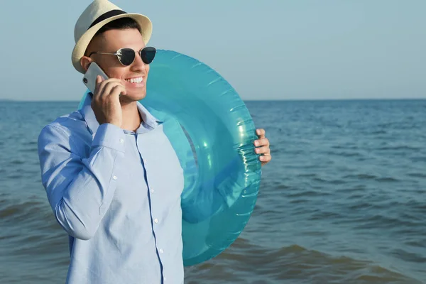Счастливый Человек Надувным Кольцом Разговаривает Мобильному Телефону Возле Моря Пляже — стоковое фото
