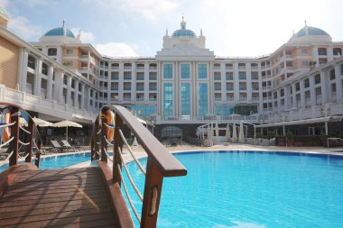Tatil köyünde yüzme havuzu olan güzel bir otel manzarası.