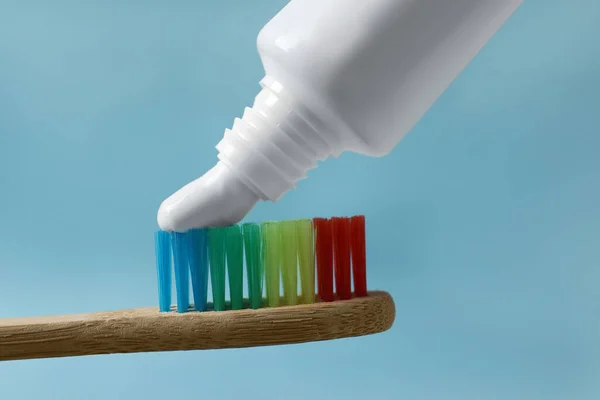 Squeezing Toothpaste Brush Light Blue Background Closeup — Stock Photo, Image