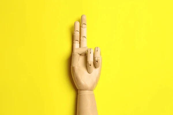 Wooden Mannequin Hand Yellow Background Top View — 图库照片