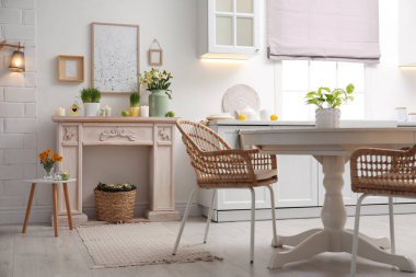 Kapalı alanda güzel bahar çiçekleri olan dekoratif bir şömine. İç tasarım