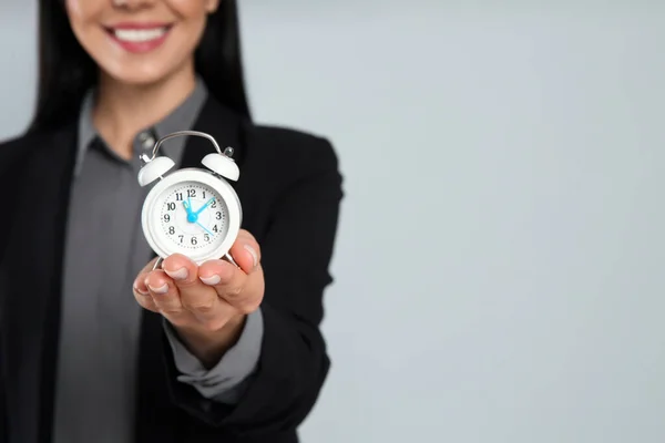 Businesswoman Holding Alarm Clock Light Grey Background Closeup Space Text — Stock Photo, Image
