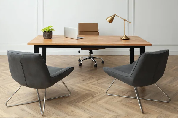 Director's office with large wooden table and comfortable armchairs. Interior design