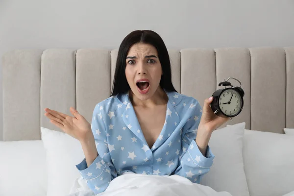 ベッドで目覚まし時計を持つ感情的なオーバーレット女性 後半の概念 — ストック写真