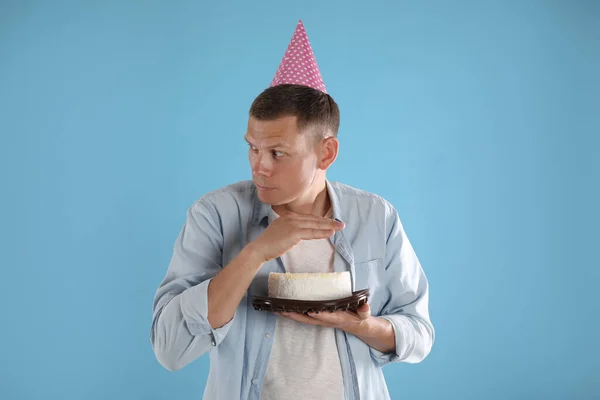 Greedy Man Party Hat Hiding Birthday Cake Turquoise Background — Stock Photo, Image