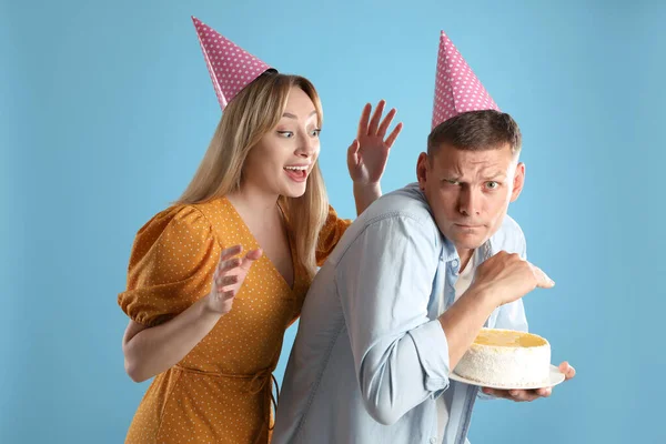 Greedy Man Hiding Birthday Cake Woman Turquoise Background — Stock Photo, Image