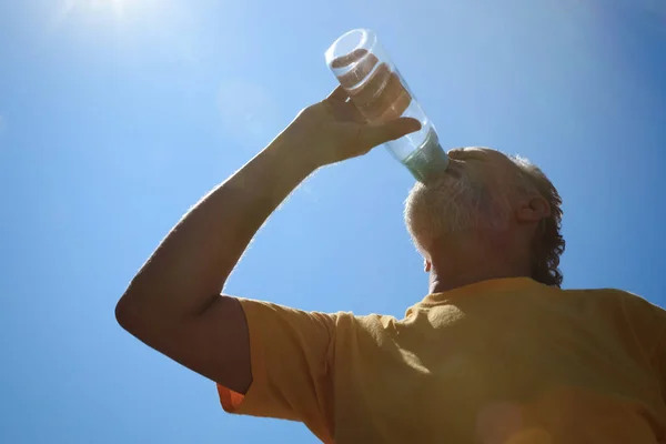 Senior Man Drinking Water Prevent Heat Stroke Outdoors Low Angle — Stock Photo, Image