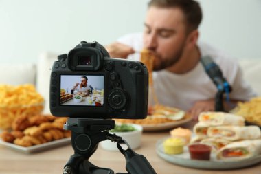 Gıda blogcusu yemek programının arka planda ışığa karşı, kamera ekranına odaklan. Mukbang vlog