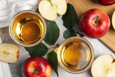 Gri masada lezzetli elma şırası ile düz bir kompozisyon.