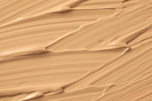 Texture of liquid skin foundation as background, closeup