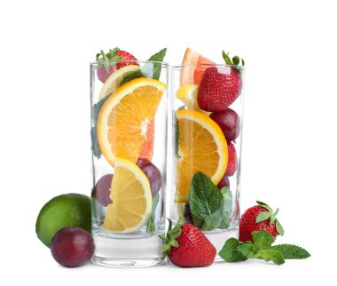 Farklı bir bütüne sahip bardaklar ve beyaz arka planda meyve kesimi