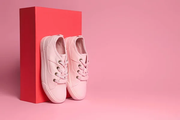 Een Paar Stijlvolle Canvas Schoenen Een Doos Een Roze Achtergrond — Stockfoto