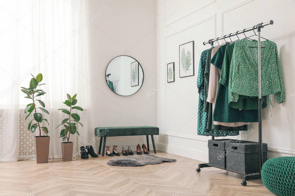 Modern room with clothes rack and mirror. Interior design